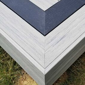 Close-up of Deckorators decking with a contrasting border, showcasing a precision-built corner detail