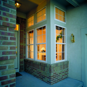 Wincore windows in a doorway with brick accents and exterior lighting
